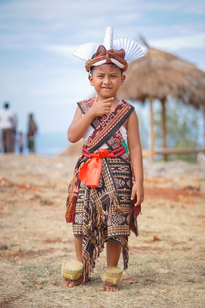 boys wearing traditional clothes from sabu island and wear attributes for a Pedo'a dance