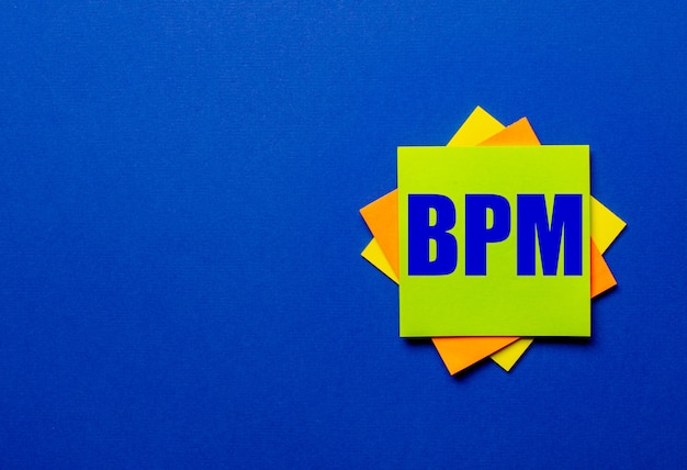 BPM is written on bright stickers on a blue surface