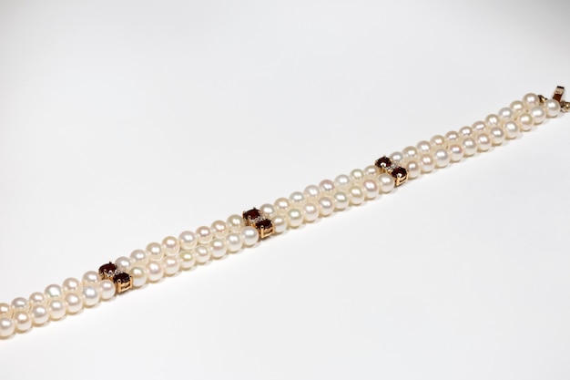 A bracelet made of natural pearls, garnet and diamonds with a gold clasp. Yellow gold and precious stones