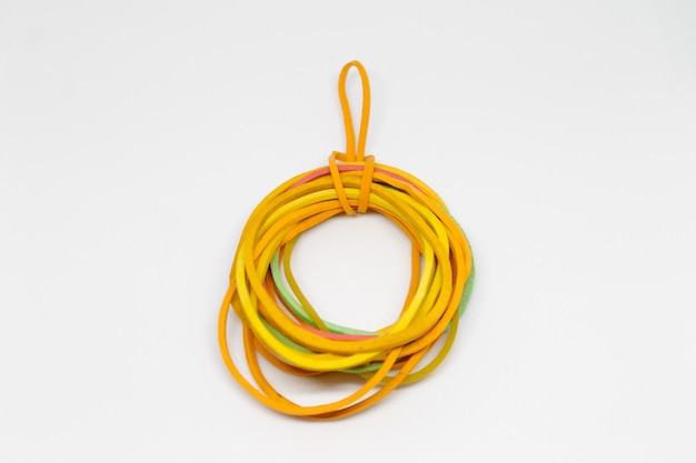 A bracelet made of orange and green rope and a string of orange and green rope.