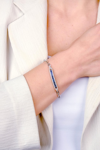 a bracelet with a blue sapphire and silver clasp