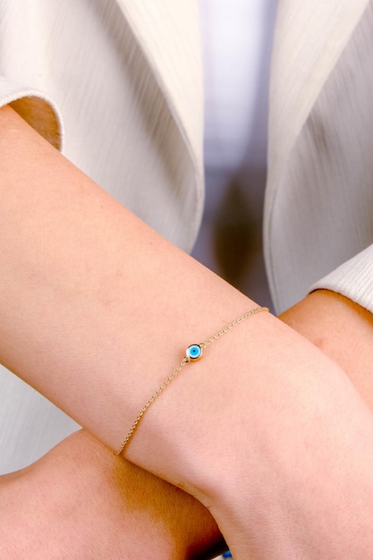 a bracelet with a blue stone on it is on a womans wrist