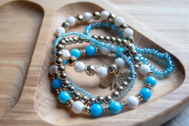 Premium Photo  Bracelets made of bisser blue white and gold beads