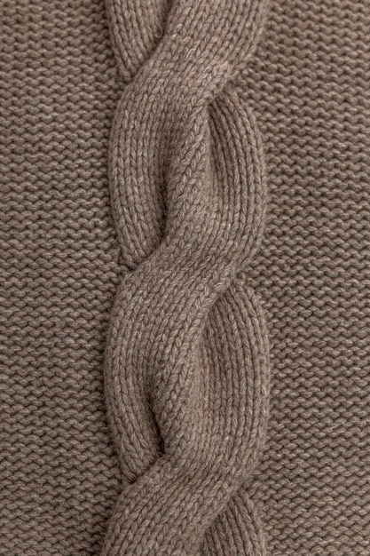 Braid pattern on knitted fabric Hobby and needlework Closeup Vertical