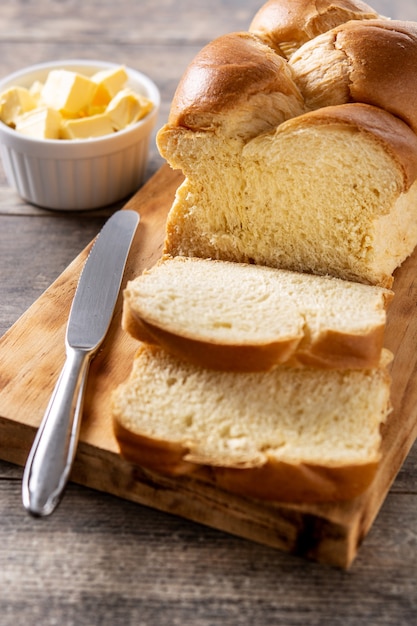 Braided egg bread on wooden table