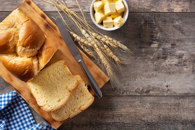 Braided egg bread on wooden table