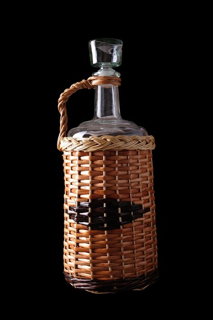 Braided wine bottle isolated on black