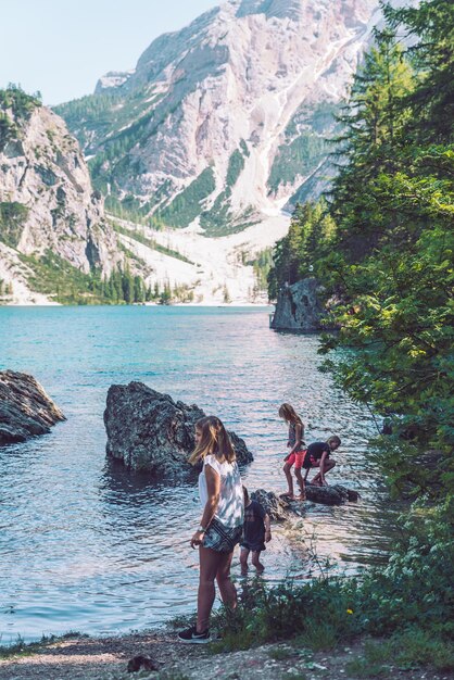 BRAIES ITALY June 13 2019 kids playing at lake beach in summer time