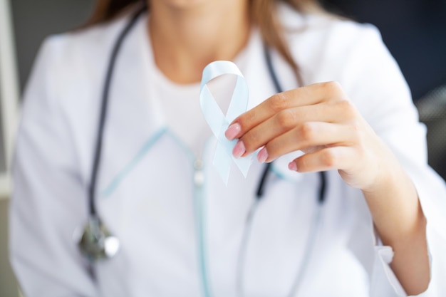 Brain cancer awareness month woman hand holding white color ribbon