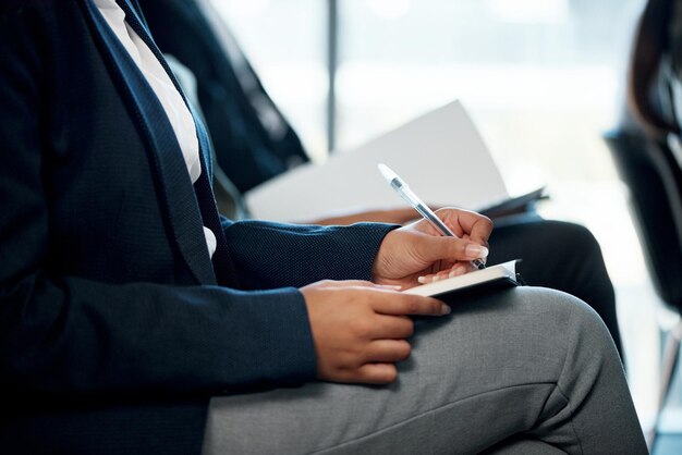 Brains are mansions Shot of a group of unrecognizable businesspeople taking notes during a meeting in an office