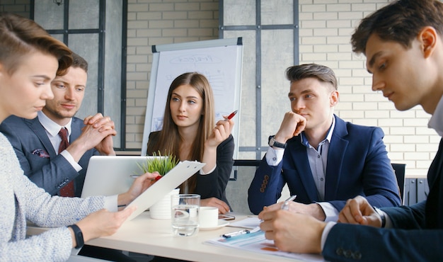 Brainstorm. group of business people looking at the laptop\
together.