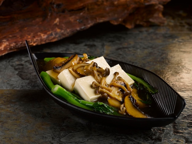 Braised Beancurd with Assorted Mushroom served in dish isolated on table top view of food