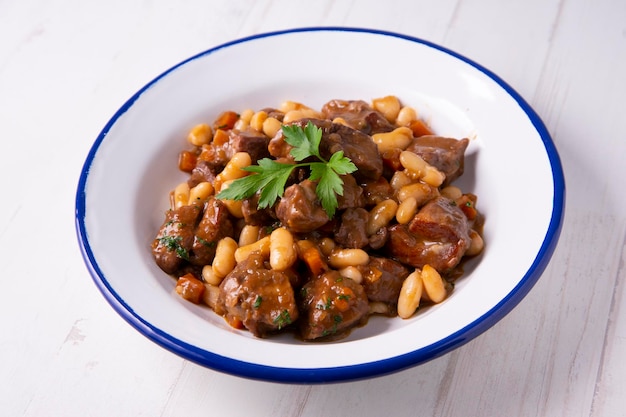 Braised beef with white beans. Traditional Spanish tapa recipe.