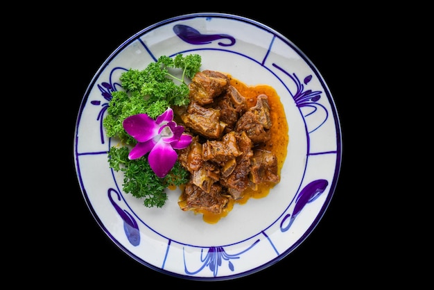 Braised pork ribs with lemongrass isolated on black background