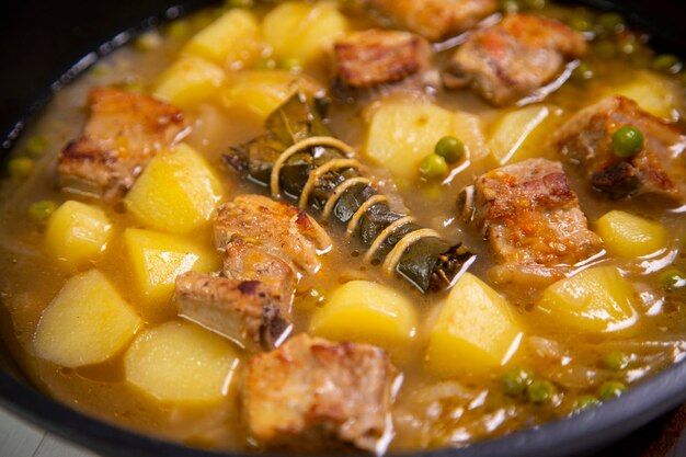 Braised pork with potatoes and vegetables. Spanish tapa recipe.