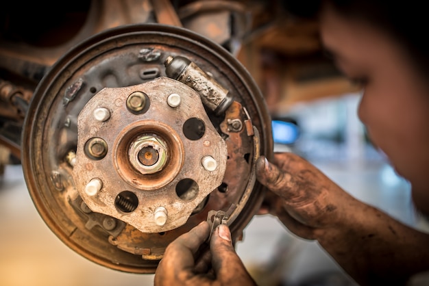 Brake repair or inspections of brake systems and the replacement of new brake pads held by mechanics who change car brake pads in car repair shops