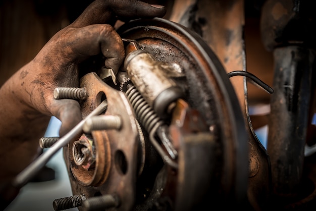 Photo brake repair or inspections of brake systems and the replacement of new brake pads held by mechanics who change car brake pads in car repair shops