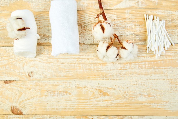 Branch of cotton plant, eared sticks, cotton pads