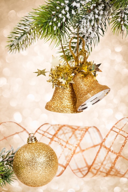 Branch of decorated Christmas tree against lights background