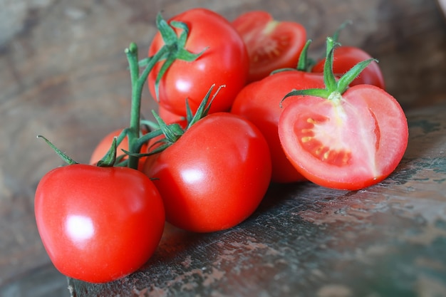 Branch of tomatoes on wooden background