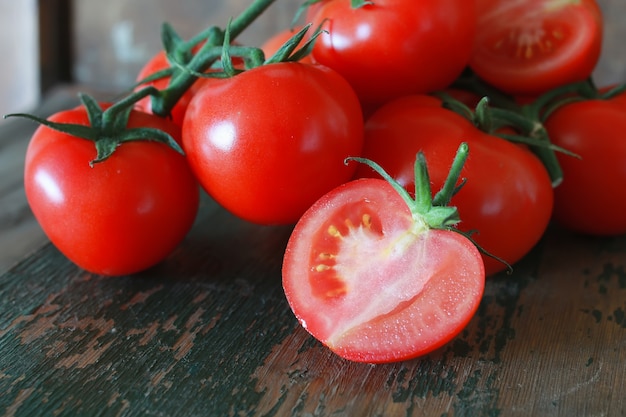 branch of tomatoes on wooden background