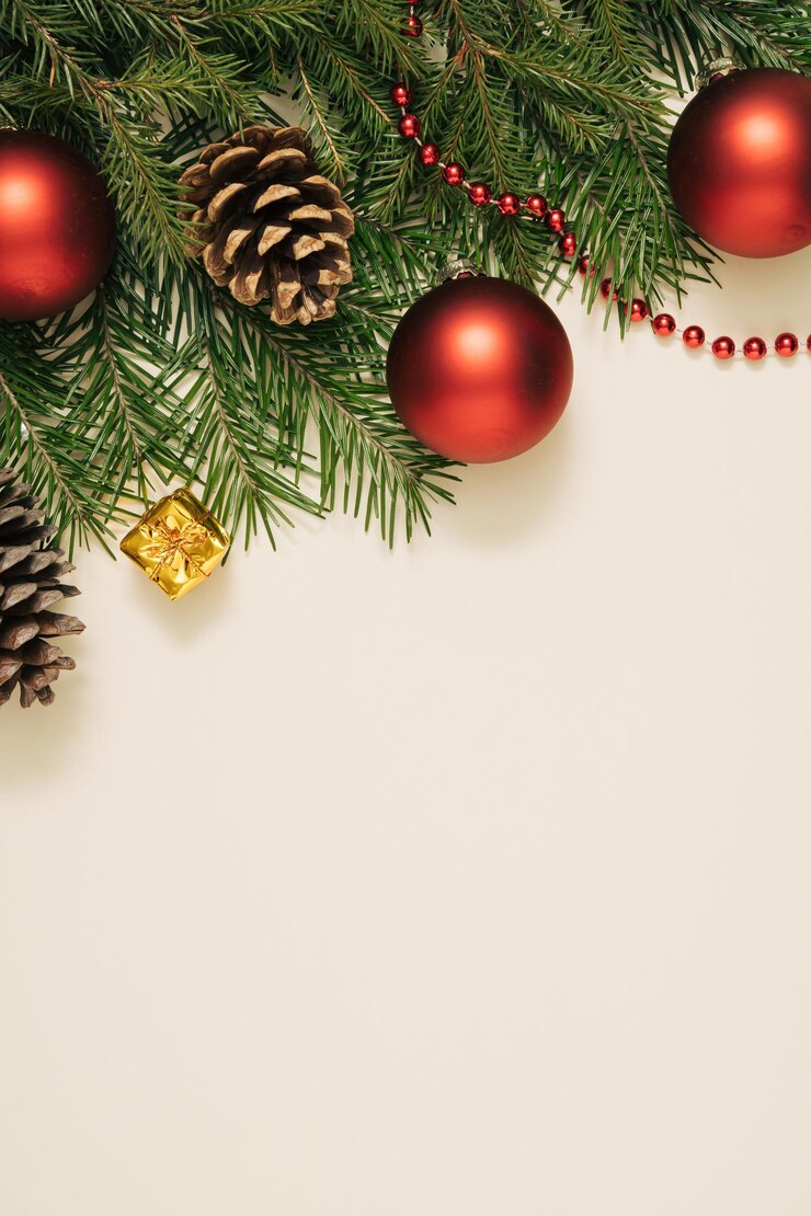 Branches of a Christmas tree, Christmas balls on a pastel beige background. Christmas composition. Minimal style. Flat layout, top view.