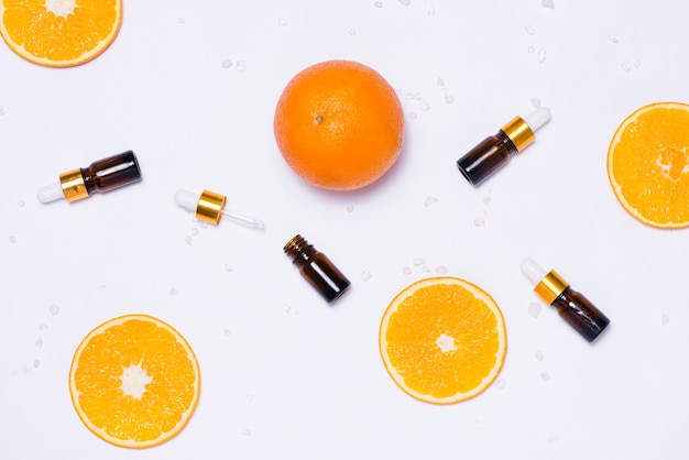 Branding mock-up. Natural essential oil, Cosmetic bottle containers with orange slices.