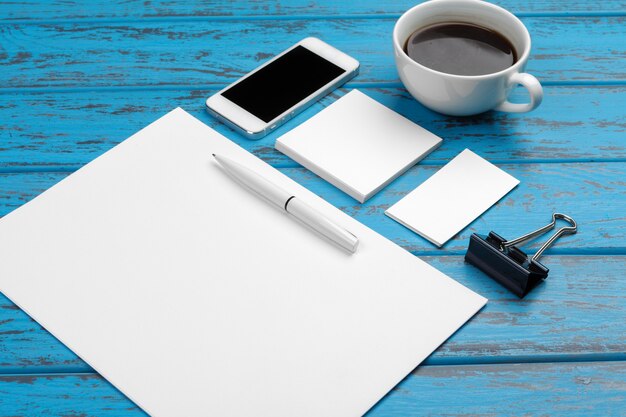 Branding stationery on blue desk. 