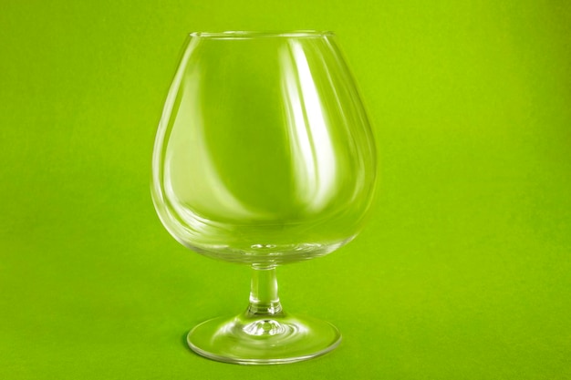 Brandy glass on green background