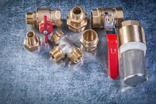 Brass lever ball valve pipe connectors strainer filter on metallic background plumbing concept