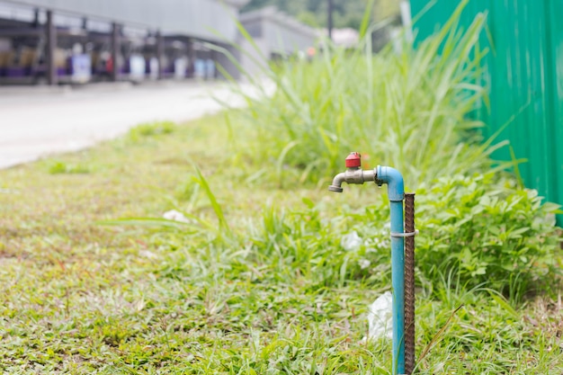 Photo brass water tap in nature