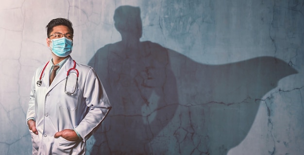 brave doctors with his shadow of superhero on the wall. concept of powerful man