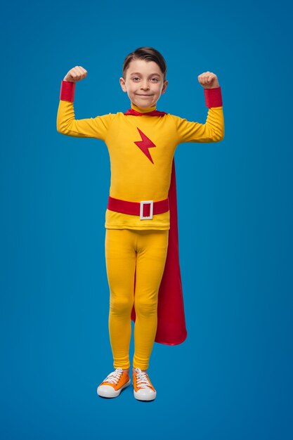 Brave superhero boy showing muscles