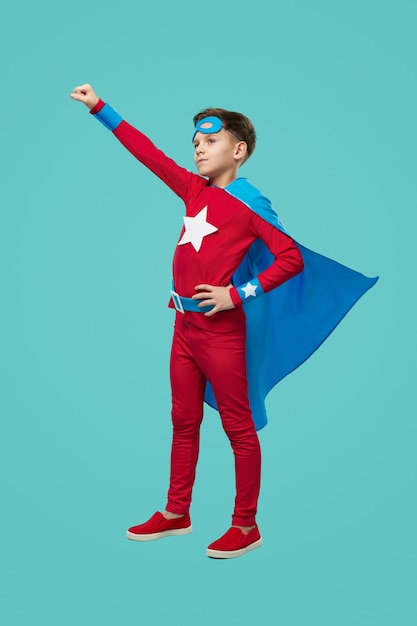 Brave superhero kid in studio