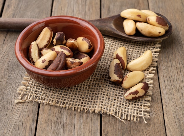 Brazil nuts in a bowl over wooden table