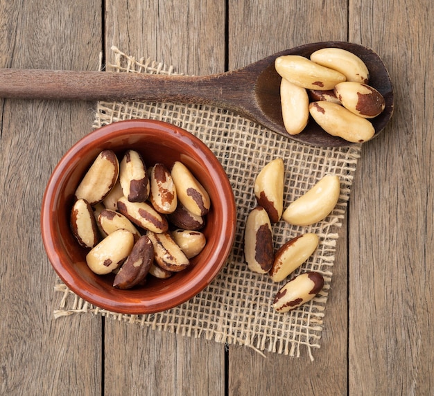 Brazil nuts in a bowl over wooden table