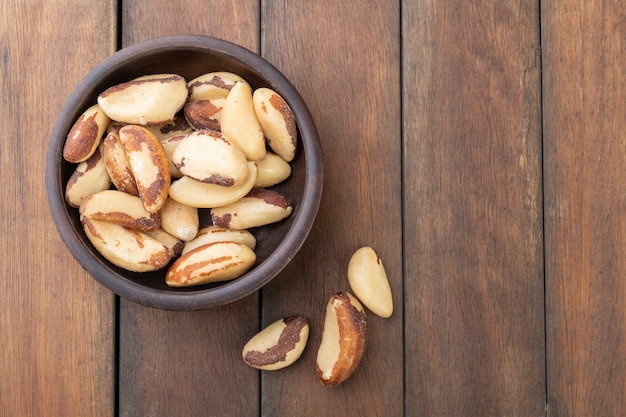 Brazil nuts on a plate over wooden table