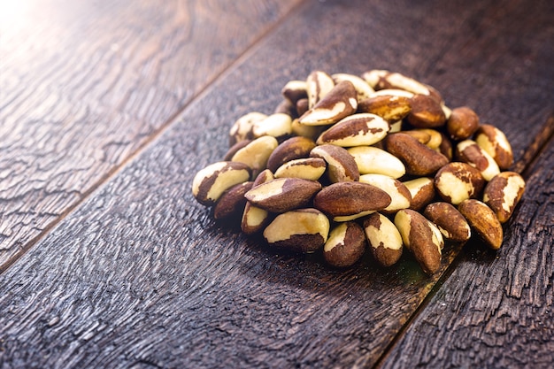 Brazil nuts, small pile of peeled Brazilian nuts on wooden background