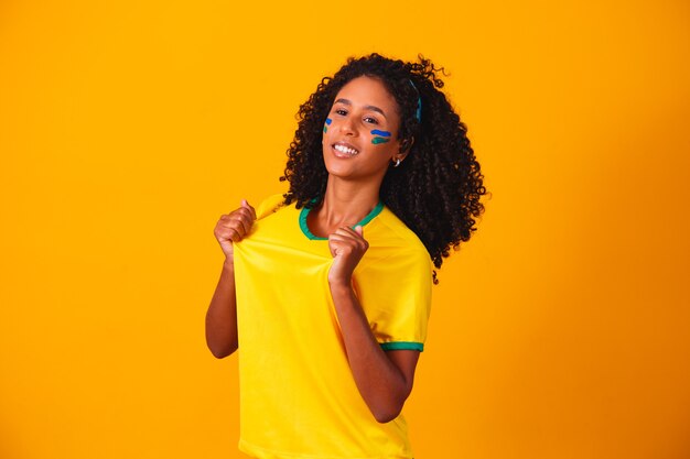 Braziliaanse fan. Braziliaanse fan die voetbal of voetbalwedstrijd viert. Kleuren van Brazilië.