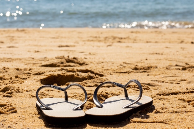 Brazilian Beach Coast. Slippers in Sand and Sea.