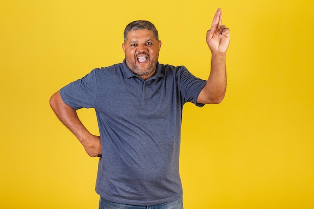 Brazilian black man adult smiling fingers crossed wishing sign of luck