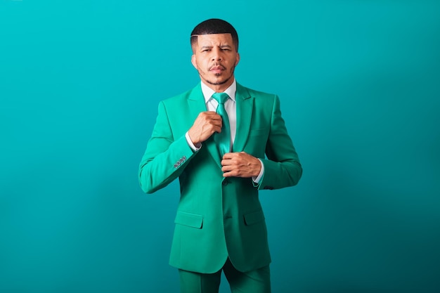 Brazilian black man dressed in suit and green tie Businessman tidying up your clothes fashion