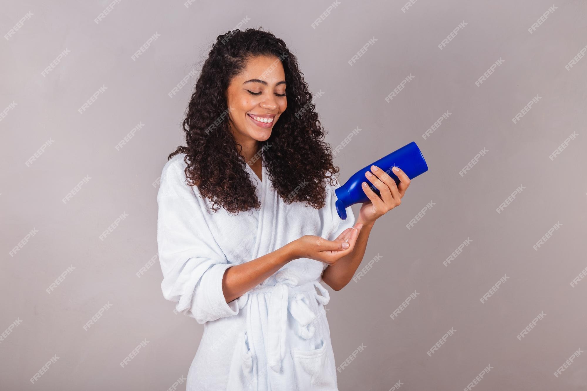 Premium Photo | Brazilian black woman wearing bathrobe and towel curly hair  spa beauty center hair care hair products
