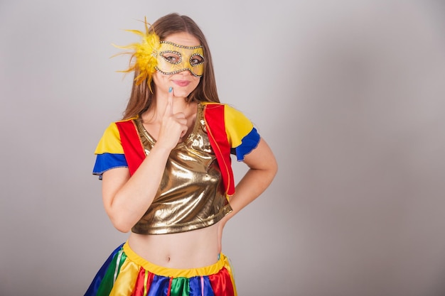 Brazilian blonde woman dressed in frevo clothes carnival mask thinking having idea