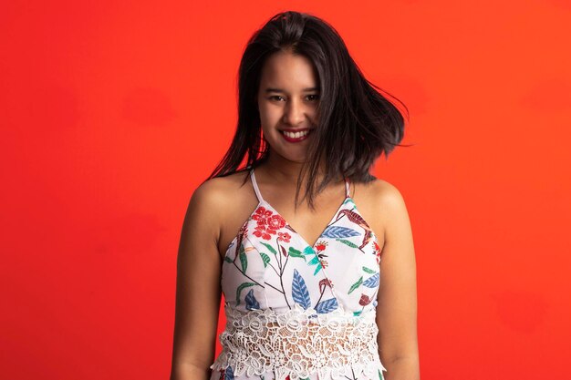 Brazilian brunette woman in flower print dress in studio