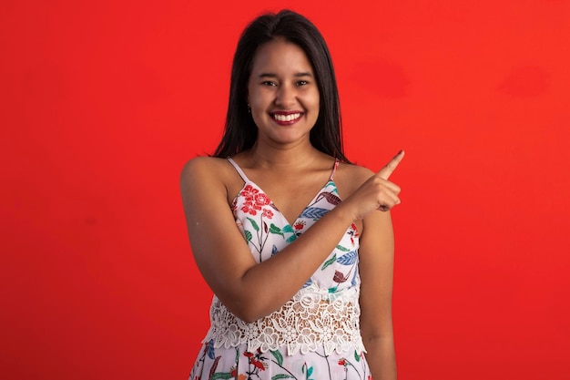 Brazilian brunette woman in flower print dress in studio