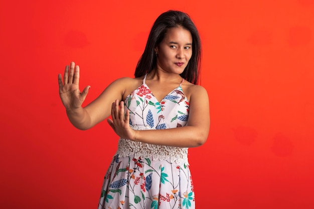 Brazilian brunette woman in flower print dress in studio