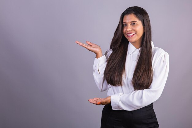 Brazilian businesswoman manager corporate portrait presenting space for advertisement publicity or product pointing out