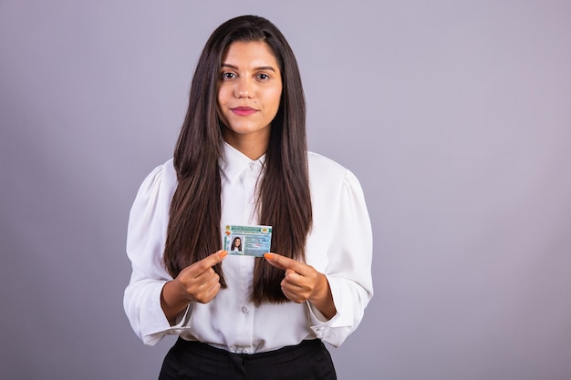 Photo brazilian businesswoman with driver's license translation in english national driver's license