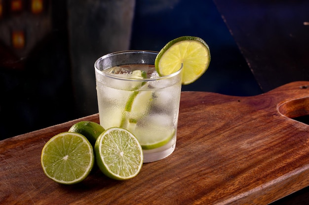 Brazilian caipirinha with ice and lemon in a glass in a studio photo